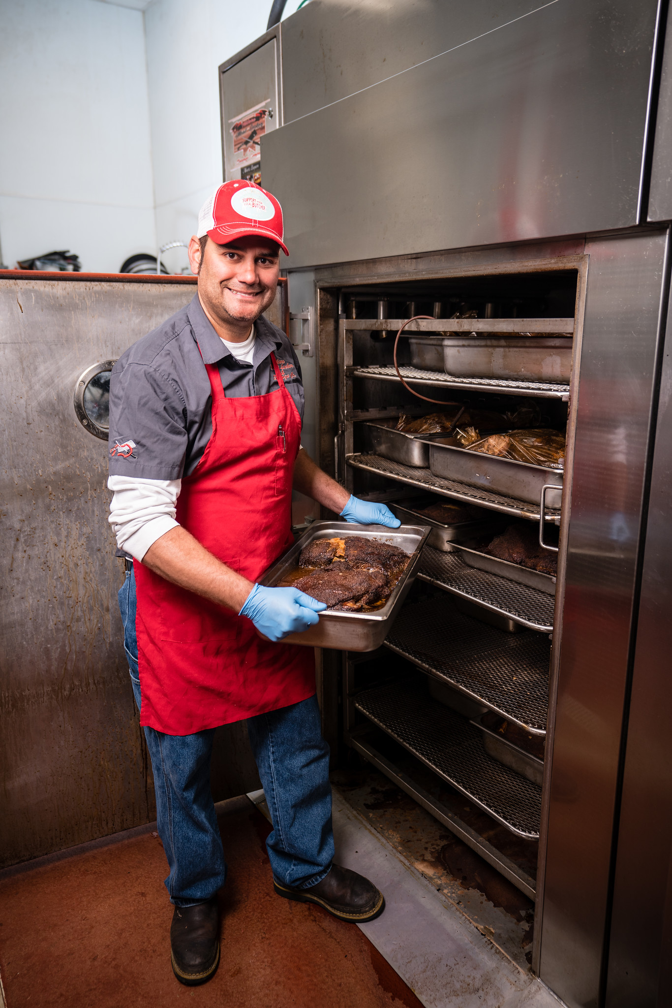 TULARE, CA--Danny Mendes pulls out a beef brisket from one of his smokers at Tulare Meat Locker & Sausage Co.  Photo by Tomas Ovalle