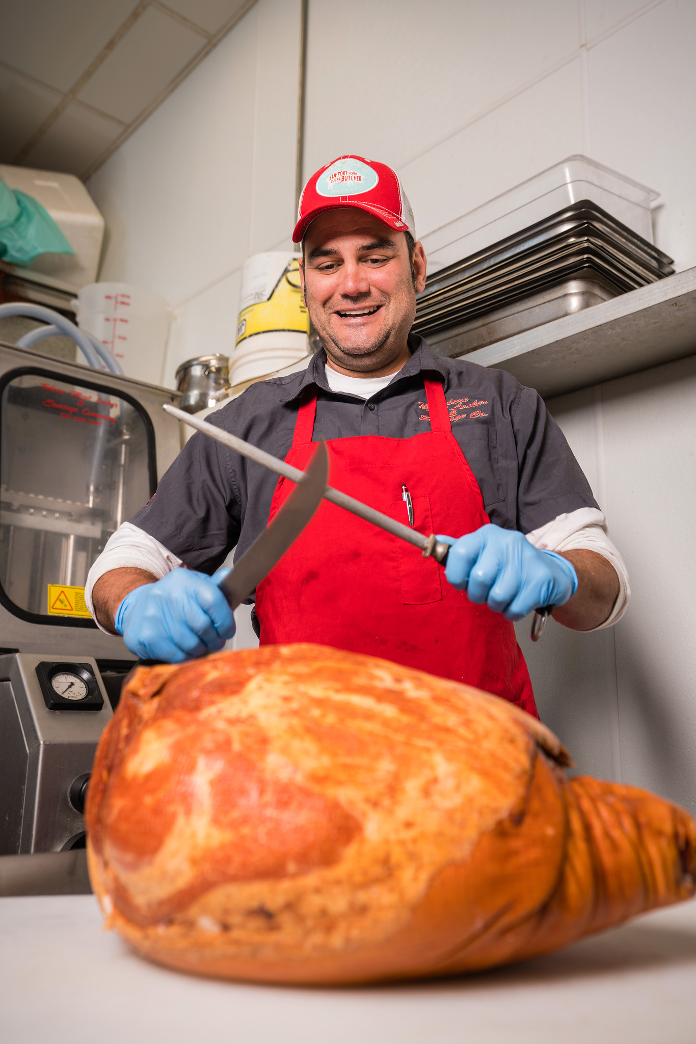 TULARE, CA--Danny Mendes works on a ham  at Tulare Meat Locker & Sausage Co. Photo by Tomas Ovalle